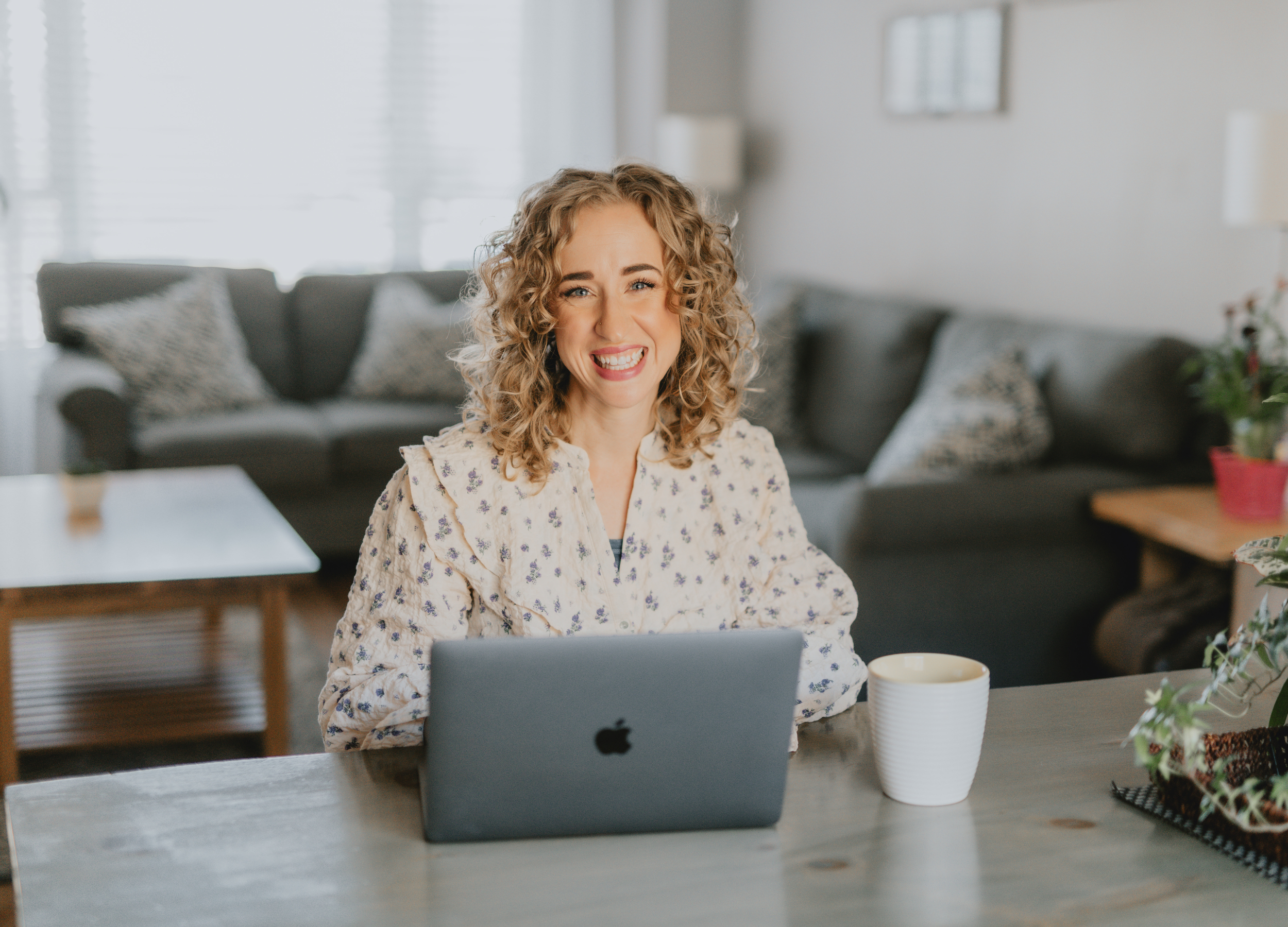 Wellness coach Danni Smith working on laptop offering online nutrition and wellness programs