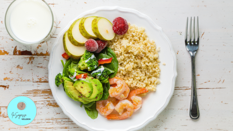 Healthy balanced plate with shrimp, vegetables, fruit, and whole grains prepared by a Wellness Coach.